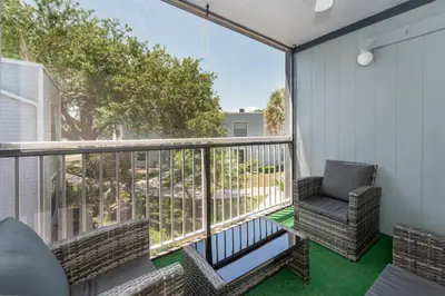 a balcony with a chair and a window at Condo with Pool, Gym, Golf, Jacuzzi and Game Areas in Orlando
