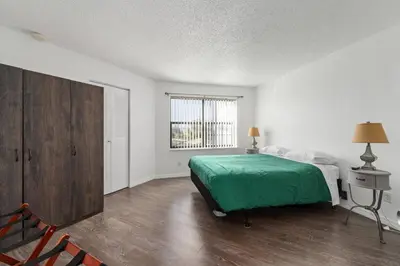 a white bedroom with a bed and a window at Cozy Apt with Pool, Hot Tub, Golf, Near Downtown in Orlando