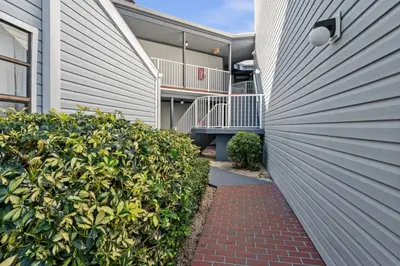 a building with a fence and a brick walkway at Cozy Apt with Pool, Hot Tub, Golf, Near Downtown in Orlando