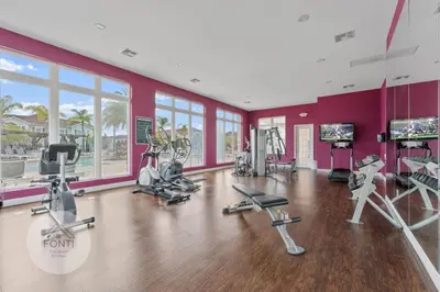 a gym with treadmills and exercise equipment in a room at 8925 Resort 4BR Townhouse by Disney World Orlando in Kissimmee