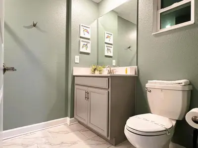 a bathroom with a toilet and a sink at 4263PD-New Listing- 5 bed/4 bath-Private Pool in Kissimmee