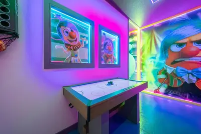 a room with a table with a painting of a cartoon at 2026 NEW Home 8 Bedrooms At Bella Vida in Kissimmee