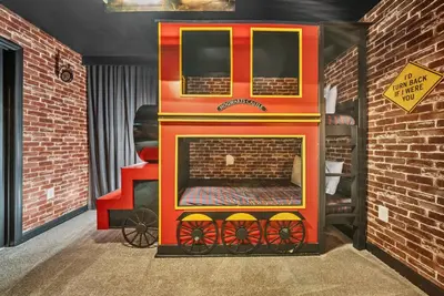 a toy fire truck in a room with a brick wall at Brand NEW Home 09 BedroomsPoolGame Room in Kissimmee