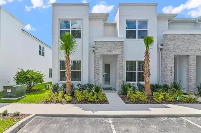 a house with palm trees in front of it at New townhouse in Clermont -Orlando area in Orlando