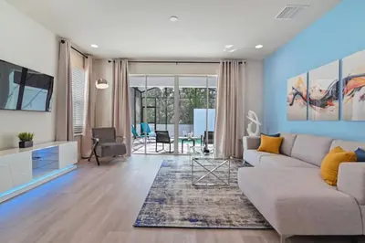 a living room with a couch and a tv at New townhouse in Clermont -Orlando area in Orlando