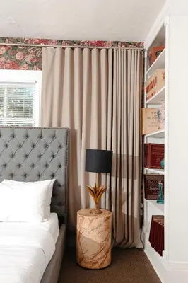 a bedroom with a bed and a table with a lamp at Norment Parry by The Wellborn in Orlando