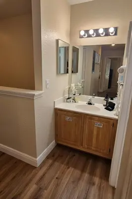 a bathroom with a sink and a large mirror at True Fantasies 101 in Kissimmee