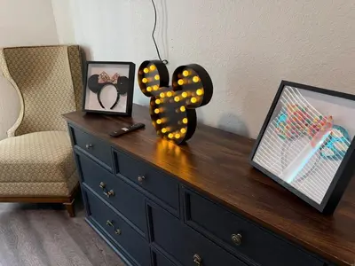 a dresser with a number on it next to a chair at Magical Condo 3 bedroom in Orlando