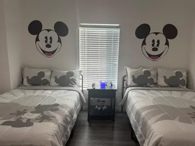a bedroom with two beds with mickey ears on the wall at Magical Condo 3 bedroom in Orlando