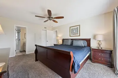 a bedroom with a bed and a ceiling fan at Near Disney! Pool and Hot Tub with Free Parking in Kissimmee