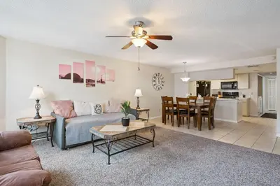 a living room with a couch and a table at Near Disney! Pool and Hot Tub with Free Parking in Kissimmee