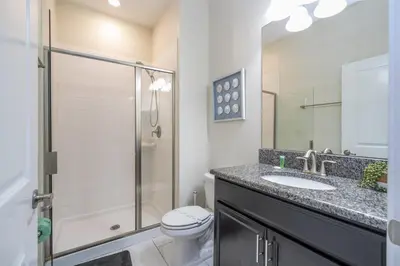 a bathroom with a toilet and a sink and a shower at Townhome 4Q c/ Piscina Privativa – Storey Lake in Kissimmee