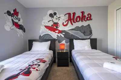 two beds in a room with a mickey mouse mural at Townhome 4Q c/ Piscina Privativa – Storey Lake in Kissimmee