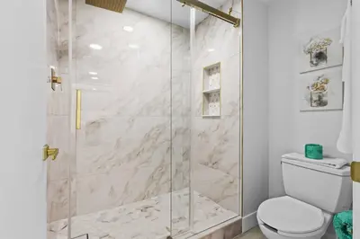 a bathroom with a shower with a toilet at Well-Located 1BR Kitchen Near Theme Parks in Orlando