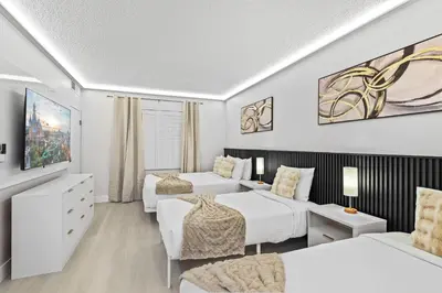 a hotel room with two beds and a couch at Well-Located 1BR Kitchen Near Theme Parks in Orlando
