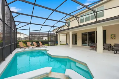 an indoor swimming pool in a house with a glass ceiling at Large Orlando Home 8BR Great Location in Kissimmee