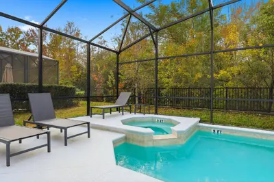 a swimming pool with two chairs and a poolificialificialificialificialificialificialificial at Large Orlando Home 8BR Great Location in Kissimmee