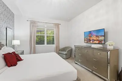 a bedroom with a bed and a television on a dresser at Large Orlando Home 8BR Great Location in Kissimmee