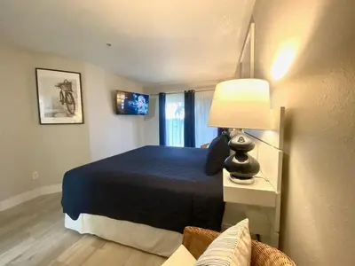 a bedroom with a bed with a lamp and a couch at Sea World Orlando Apts Parks Convention Centre in Orlando