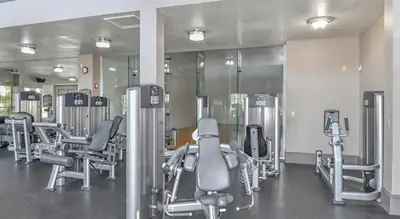 a gym with a row of chairs and mirrors at Quiet Gated Condo Near Universal with Pool and View in Orlando
