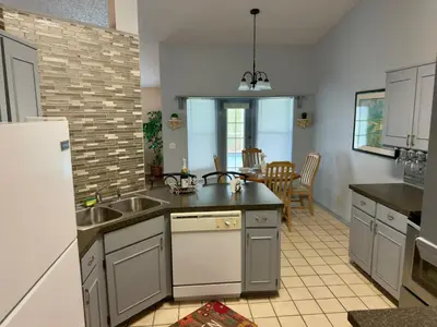 a kitchen with a sink and a refrigerator at Magic getaway in Kissimmee