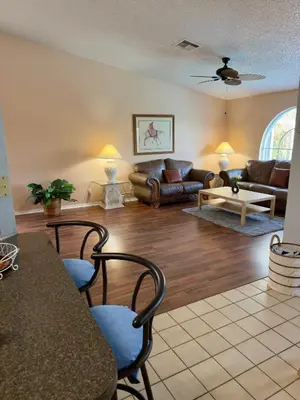 a living room with a couch and a table at Magic getaway in Kissimmee