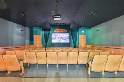 a conference room with chairs and a projection screen at Magic Palms House 10 Min to Parks in Kissimmee
