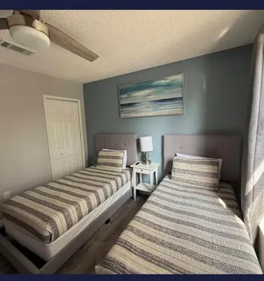 two beds sitting next to each other in a bedroom at TownHouse at Emerald Island Resort Near Disney in Kissimmee