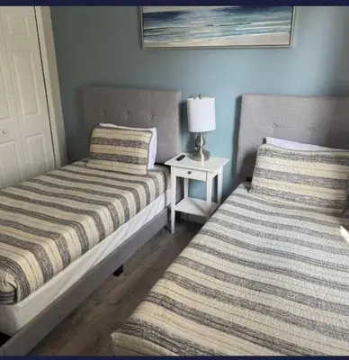 two beds sitting next to each other in a bedroom at TownHouse at Emerald Island Resort Near Disney in Kissimmee