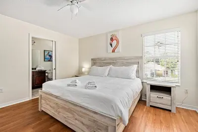 a bedroom with a large bed and a window at Family Retreat at Lake Berkley Resort! in Kissimmee