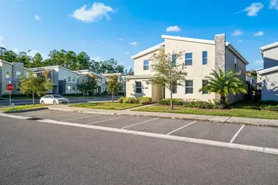 an empty parking lot in front of a house at Close to Disney! Pool, Spa, Game, & Movie Room! in Kissimmee