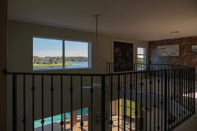 a room with a staircase with a large window at 5BR 4BA Pool Pool Table Near Disney in Kissimmee