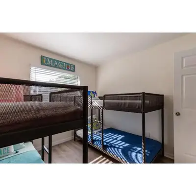 a bedroom with two bunk beds in a room at Dream Getaway Nr Disney! Own Pool & Modern Feel! in Orlando