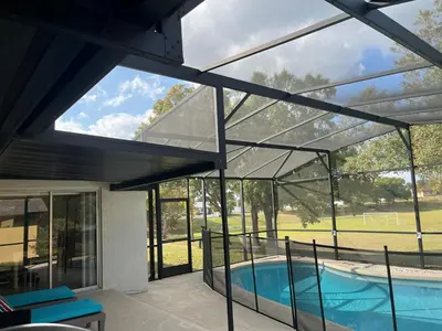 a house with a swimming pool and glass walls at Dream Getaway Nr Disney! Own Pool & Modern Feel! in Orlando