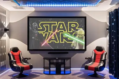 a tv in a room with a video game on the screen at Close to Disney! Pool/Spa/Game & Movie room! in Kissimmee