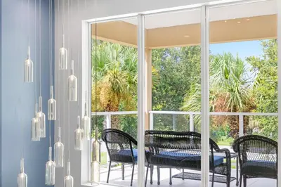a dining room with a table and chairs in front of a window at Villa near Orlando's Attractions in Orlando