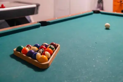 a box of billiard balls on a pool table at Gated Pool Home 20 Min to Disney, Uni, MCO in Kissimmee