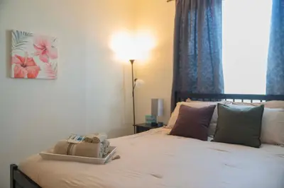 a bedroom with a bed with a stuffed animal on it at Gated Pool Home 20 Min to Disney, Uni, MCO in Kissimmee