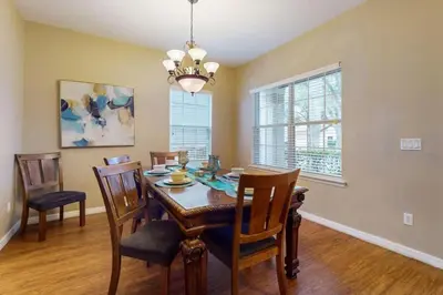 a dining room with a table and chairs at 8033 Acadia Estates Court in Orlando
