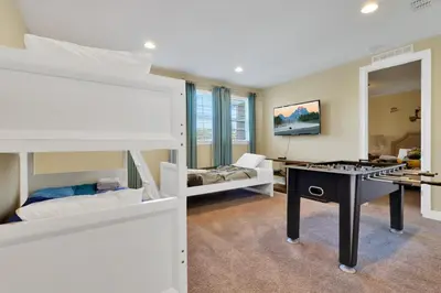 a room with two bunk beds and a desk at 480 Lasso Dr. · 480 Villa - Large Luxury 7BD Home - SpaPool in Orlando