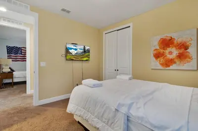 a bedroom with a bed and a painting on the wall at 480 Lasso Dr. · 480 Villa - Large Luxury 7BD Home - SpaPool in Orlando