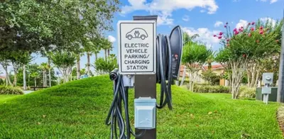 a sign for a bicycle parking charging station at 213 Hideaway Beach way in Kissimmee