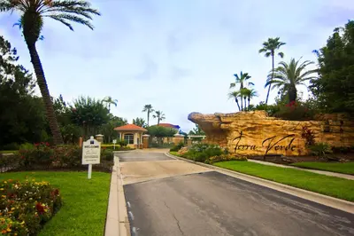 a road leading to a house with a rock wall at 213 Hideaway Beach way in Kissimmee