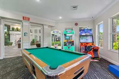 a room with a pool table and arcade games at 2232 Wyndham Palms Way in Kissimmee