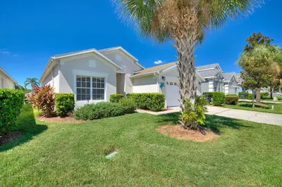 a house with a palm tree in a yard at 2232 Wyndham Palms Way in Kissimmee