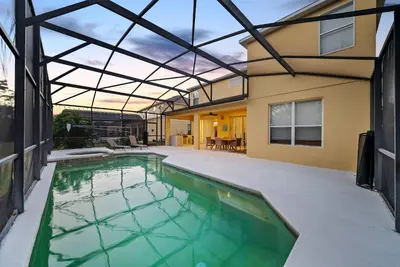 an indoor swimming pool in a house with a glass ceiling at Cozy Villa 08 BedroomsPoolGame Room in Kissimmee