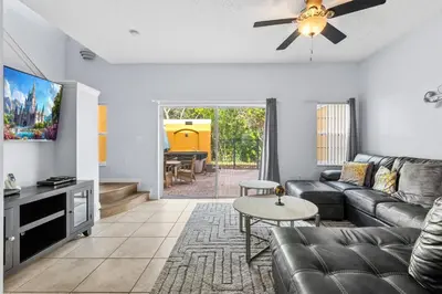 a living room with a couch and a tv at Family Escape! HotTub+Grill+Disney! in Kissimmee