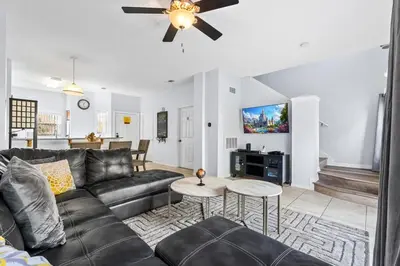 a living room with a couch and a ceiling fan at Family Escape! HotTub+Grill+Disney! in Kissimmee