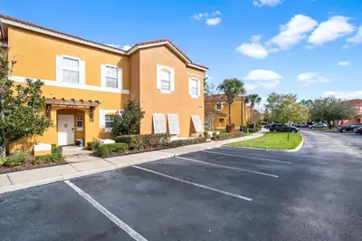 an empty parking lot in front of a building at Family Escape! HotTub+Grill+Disney! in Kissimmee