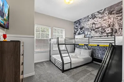 a bedroom with two bunk beds and a wall with a mural at Luxury 4BR Resort Villa @ Lucaya Village in Kissimmee
